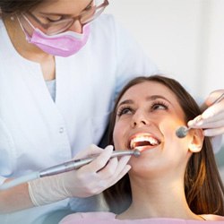 a patient smiling while undergoing restorative dentistry  